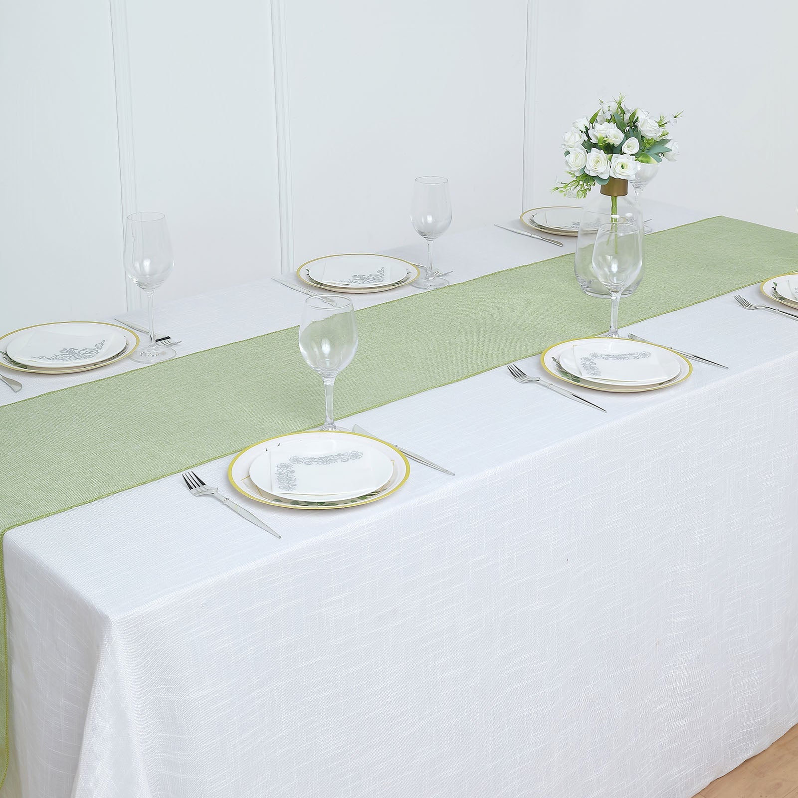 Sage green boho chic rustic faux jute linen table runner on a dining table.