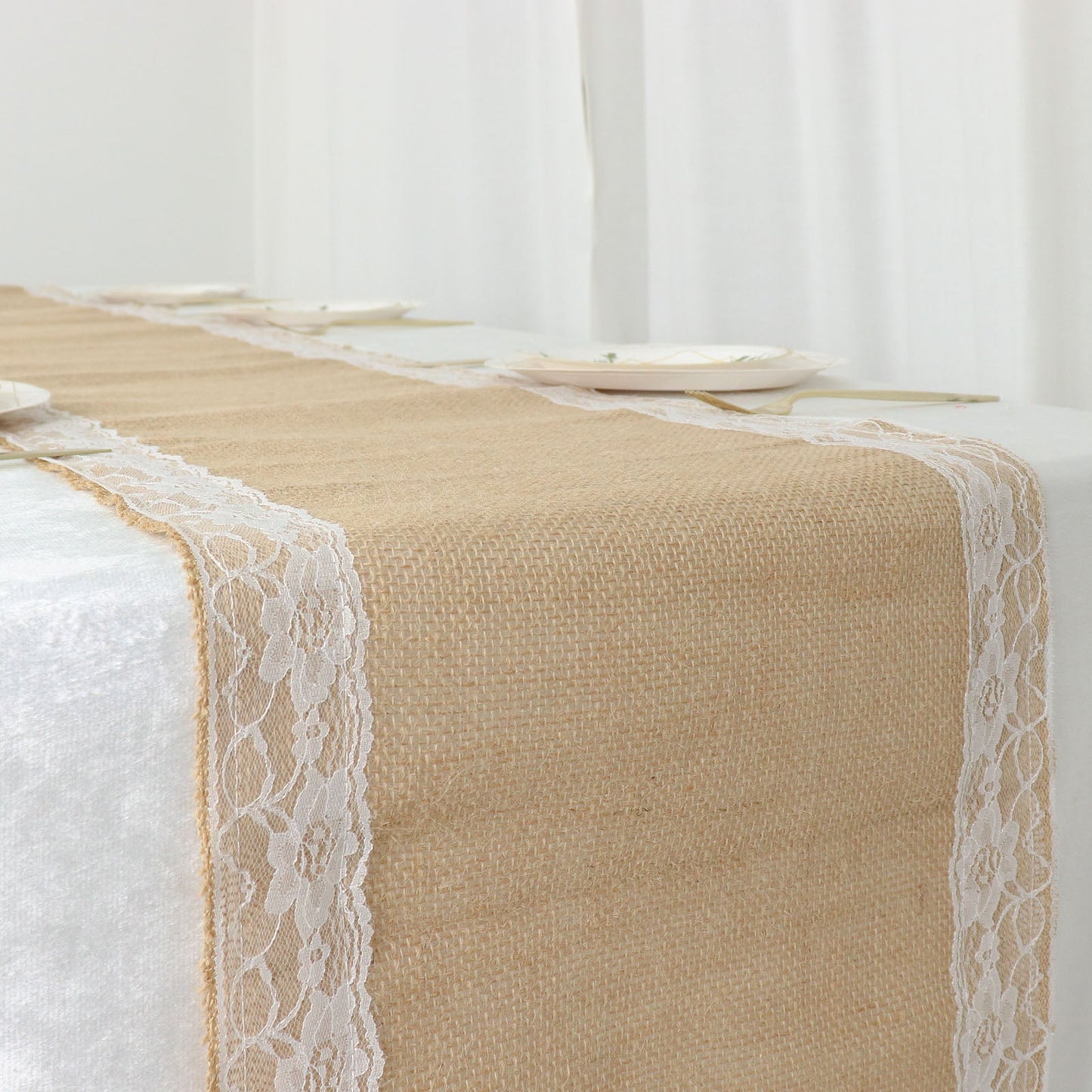 Natural jute burlap table runner with white lace trim edges.