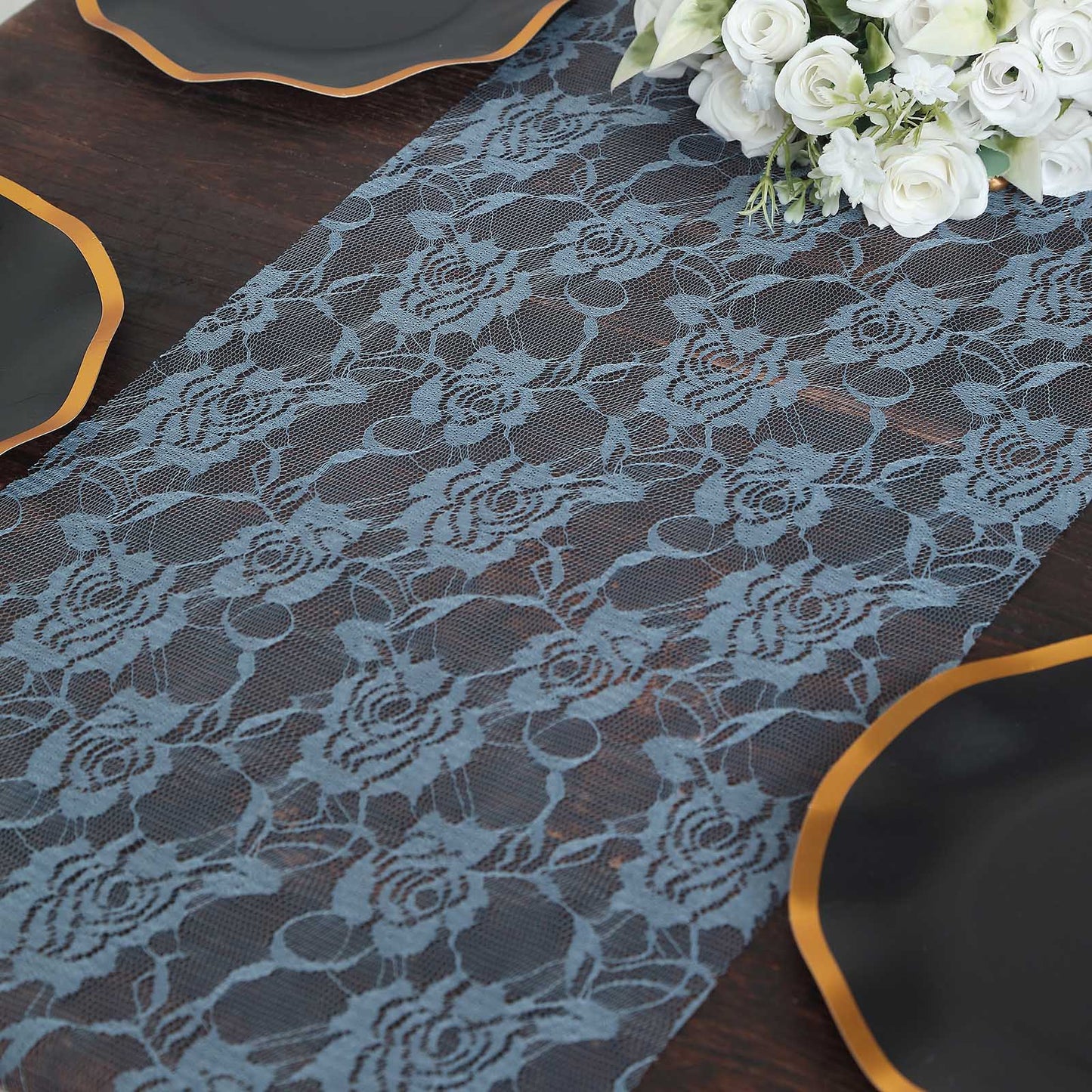 Dusty blue vintage rose lace table runner on a dark wooden table.