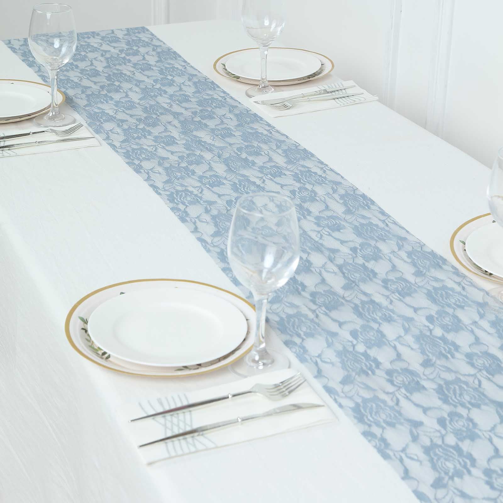 Dusty blue vintage rose lace table runner on a white table.