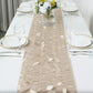 Beige 3D leaf petal taffeta fabric table runner on a dining table.