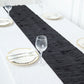 Black 3D leaf petal taffeta fabric table runner on a white table.