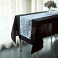 White 3D leaf petal taffeta fabric table runner on a black table.