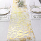 Sparkly gold foil disposable table runner on a white table setting.