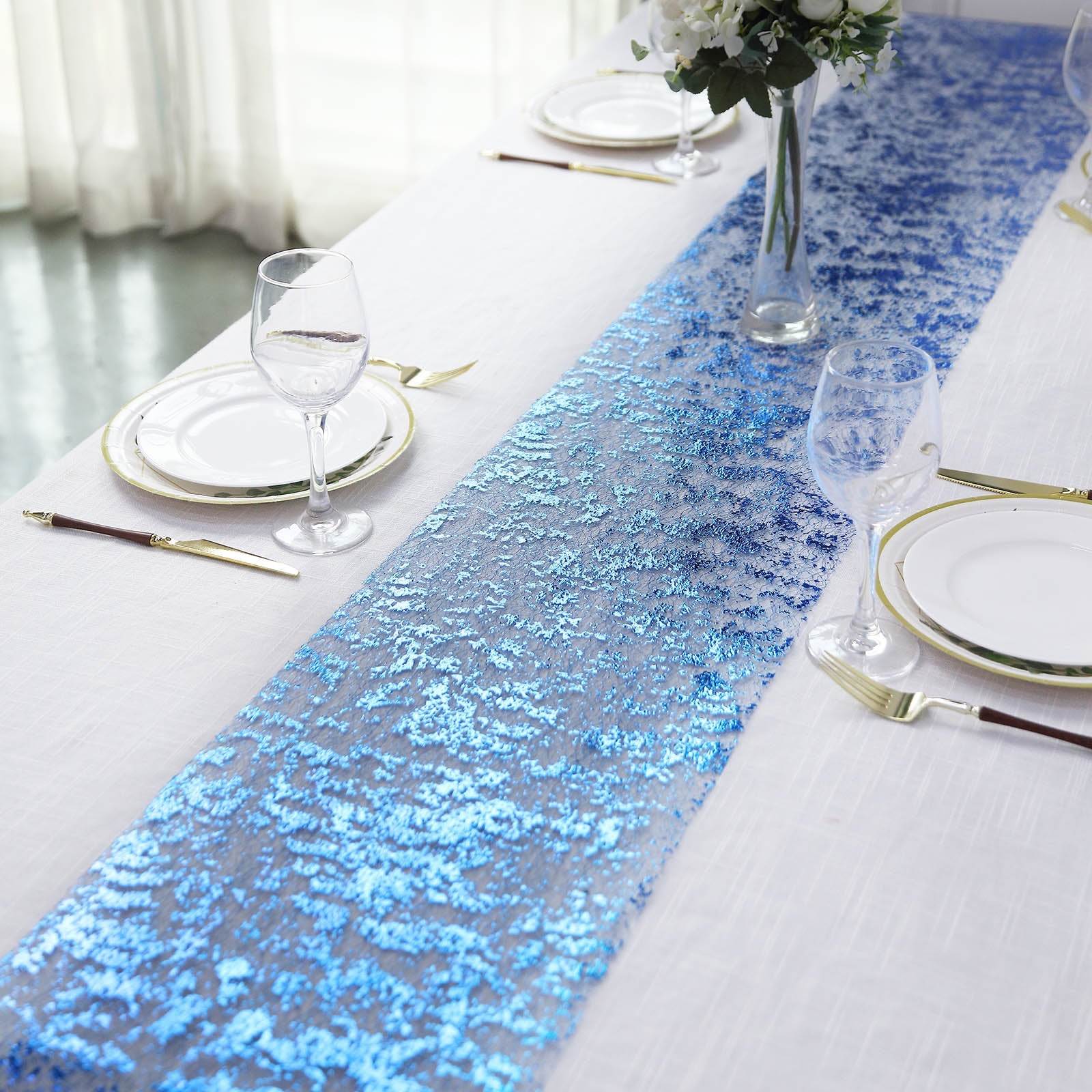 Sparkly metallic royal blue foil table runner on a white table.