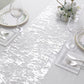 Sparkly metallic silver foil thin mesh polyester table runner on a dining table.