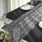 Silver sequin mesh lace table runner on a black table setting.