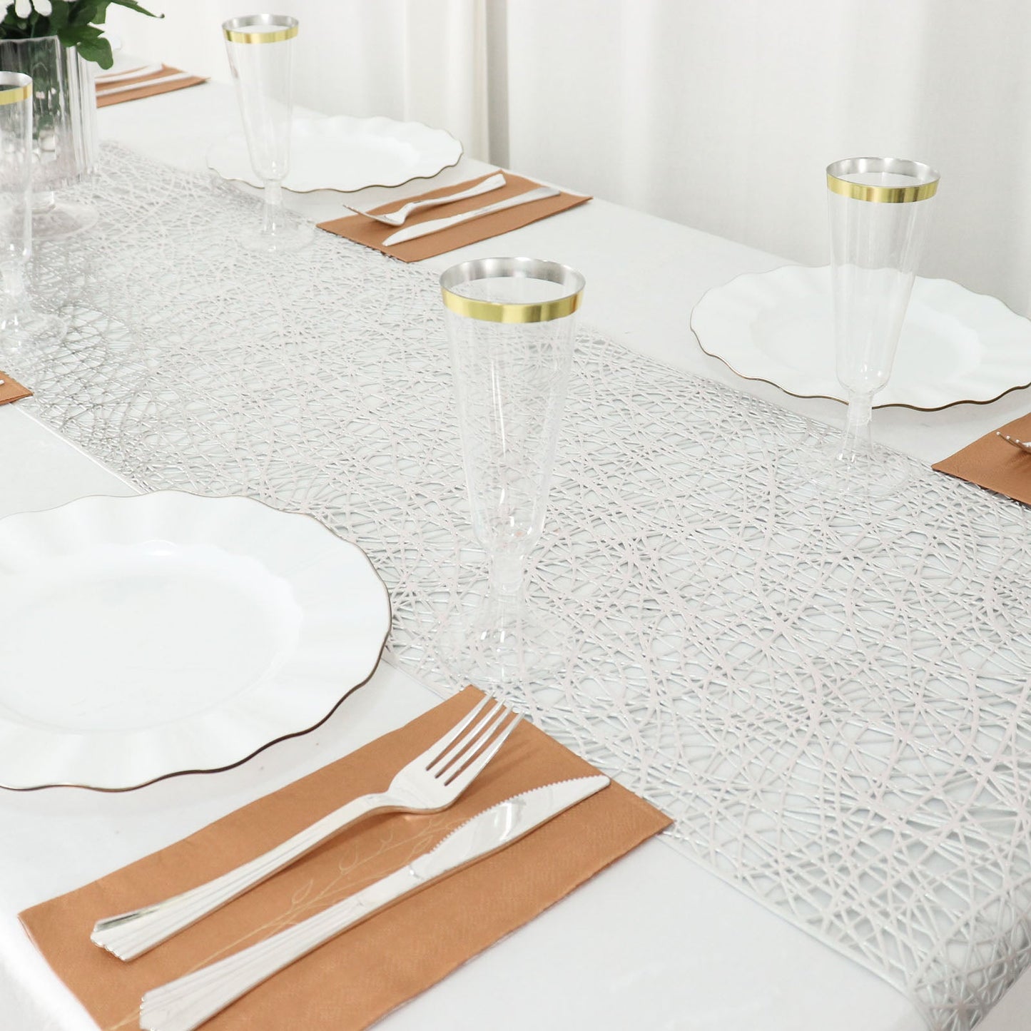Metallic silver non-slip woven vinyl table runner on a dining table.