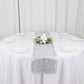 Metallic silver non-slip vinyl table runner on a round table setting.