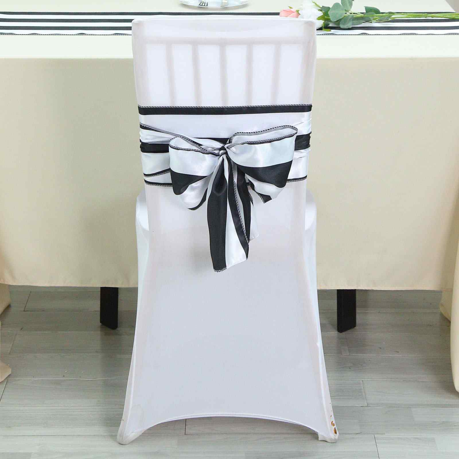 Black and white striped satin chair sash on a white chair.