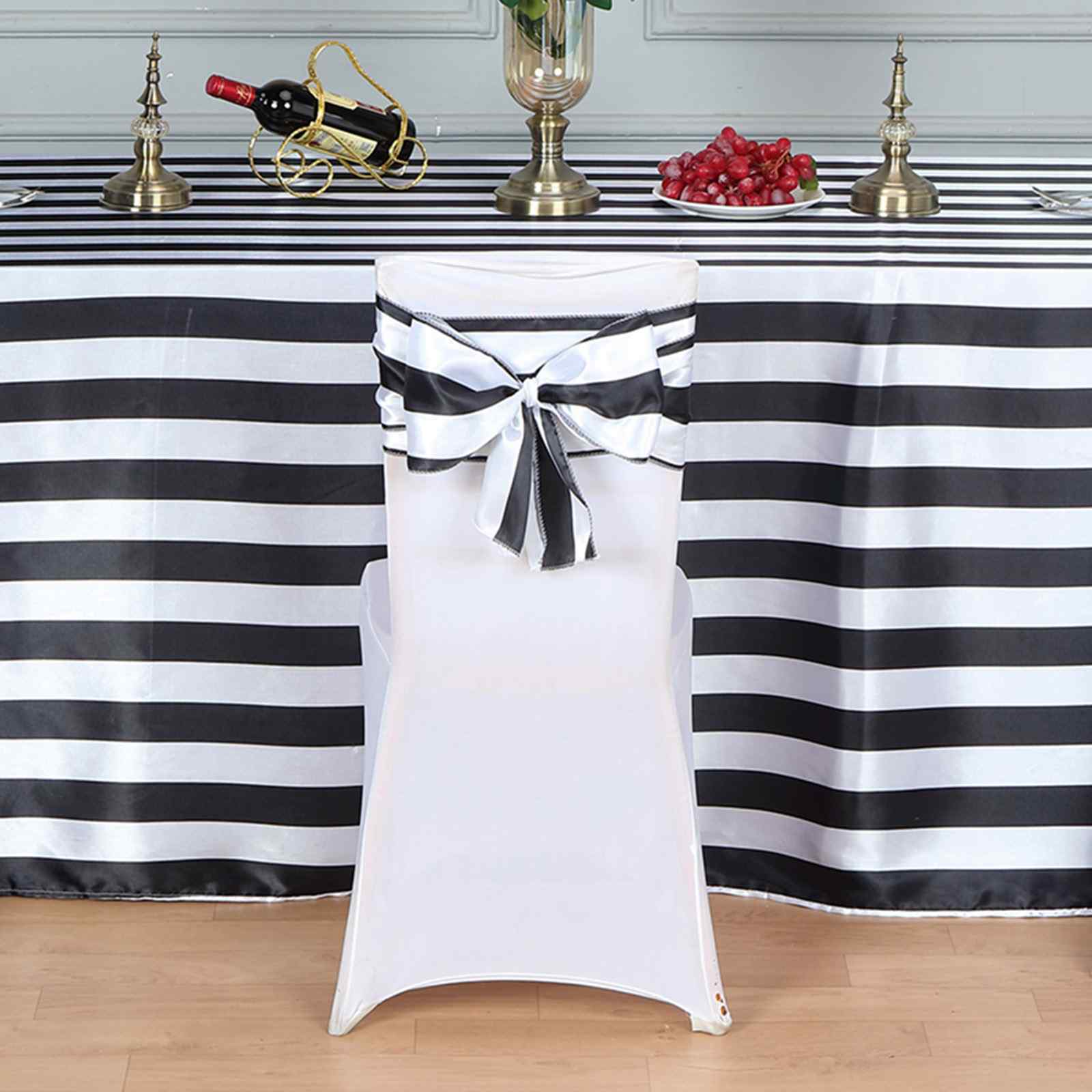 Black and white stripe satin chair sash on a white chair.