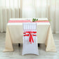 Red and white stripe satin chair sashes on a white chair at an event table.