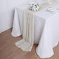 Beige chiffon table runner elegantly draped on a white table.