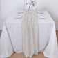Beige chiffon table runner on a white table setting.
