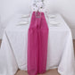 Fuchsia chiffon table runner on a white table setting.