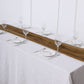 Gold chiffon table runner on a white table setting.