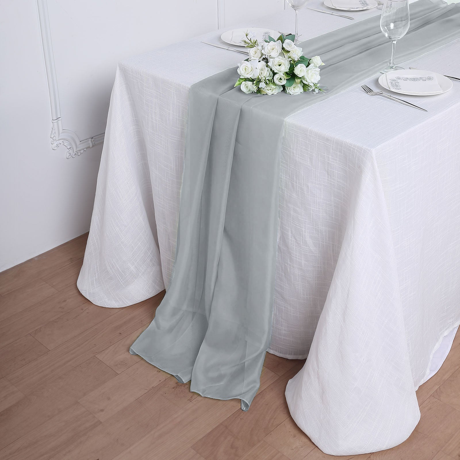 6ft silver chiffon table runner draped elegantly on a white table.