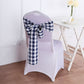 Navy blue and white checkered chair sash tied on a white chair.