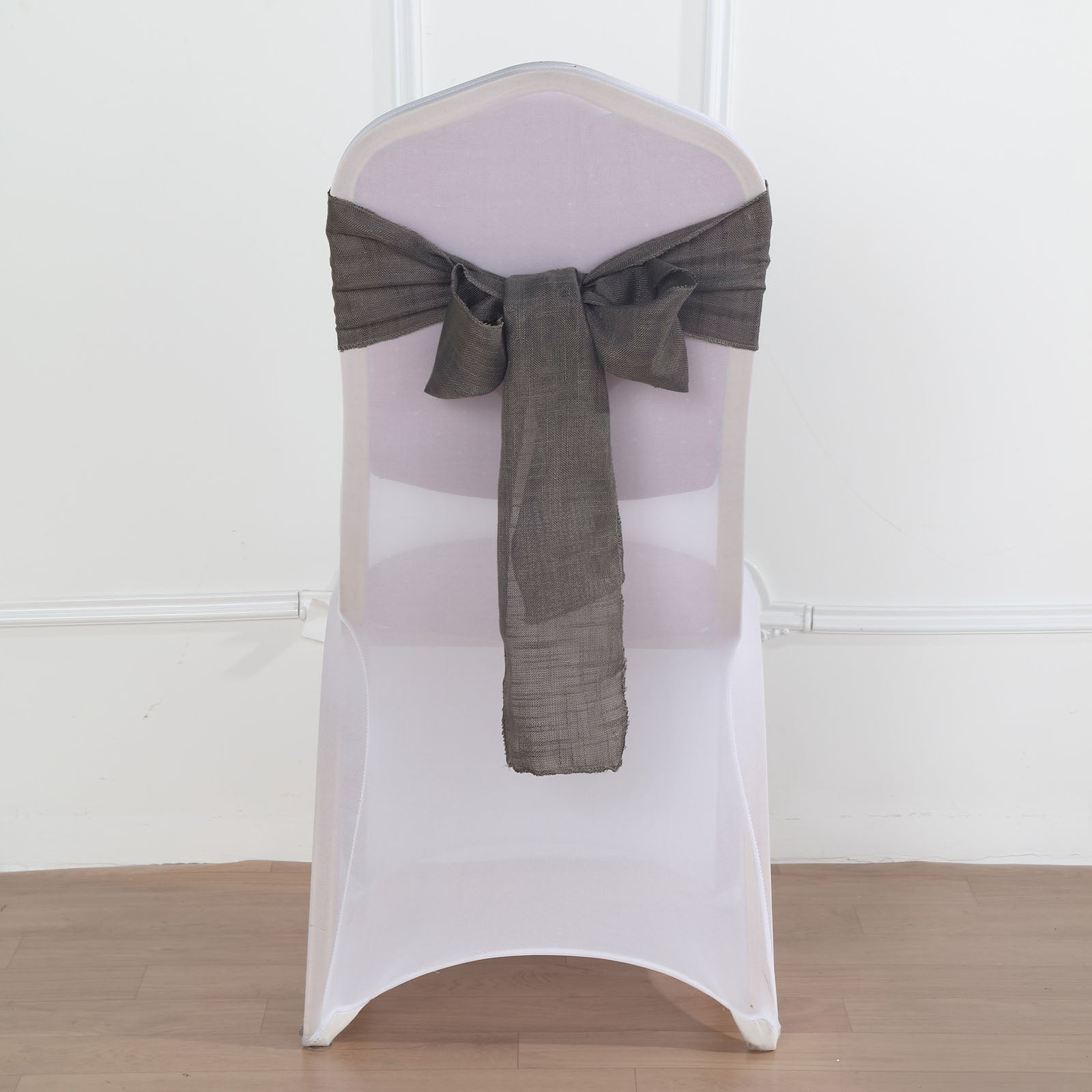 Charcoal gray linen chair sash on a white chair.