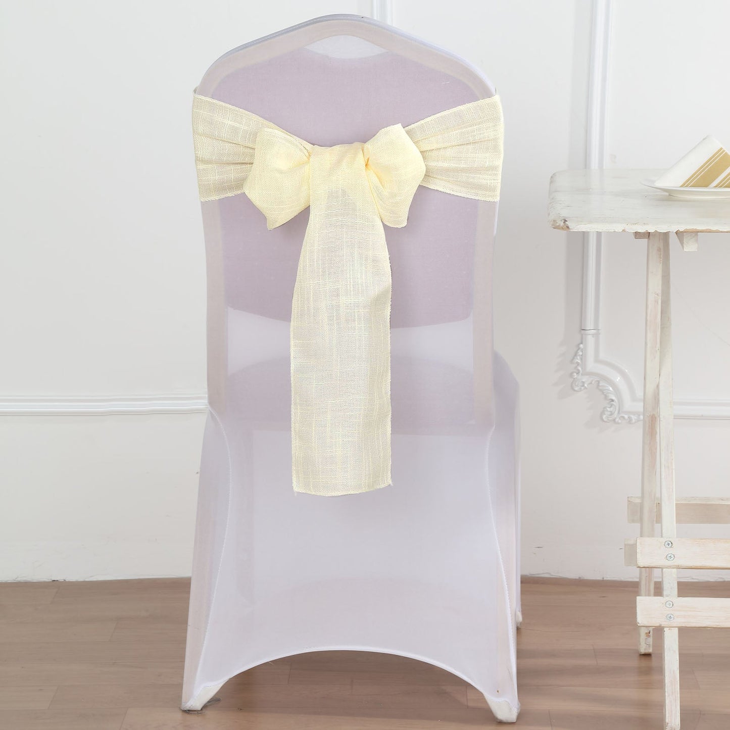 Ivory linen chair sashes with slubby texture, wrinkle resistant.