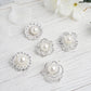 Assorted silver plated rhinestone brooches with pearl centers.