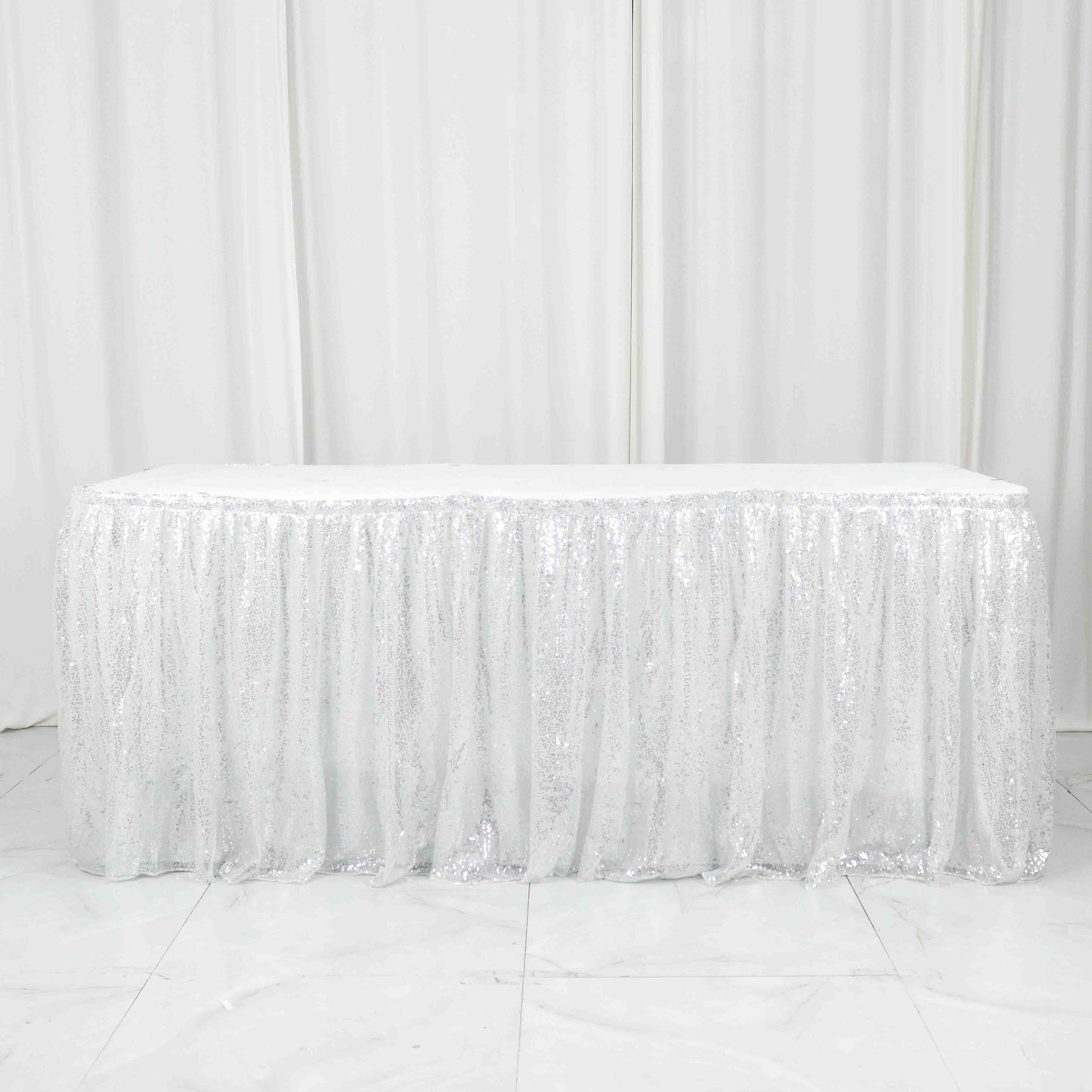 Sparkly silver sequin pleated satin table skirt with Velcro strip.