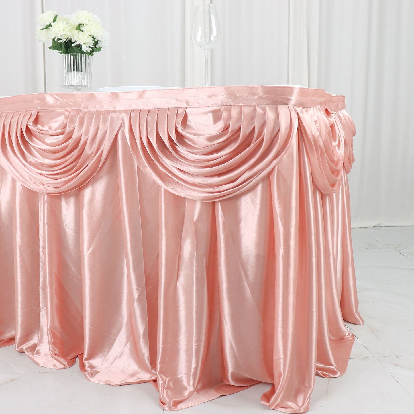 Dusty rose pleated satin double drape table skirt.