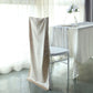 Champagne velvet Chiavari chair back slipcover on a white chair.