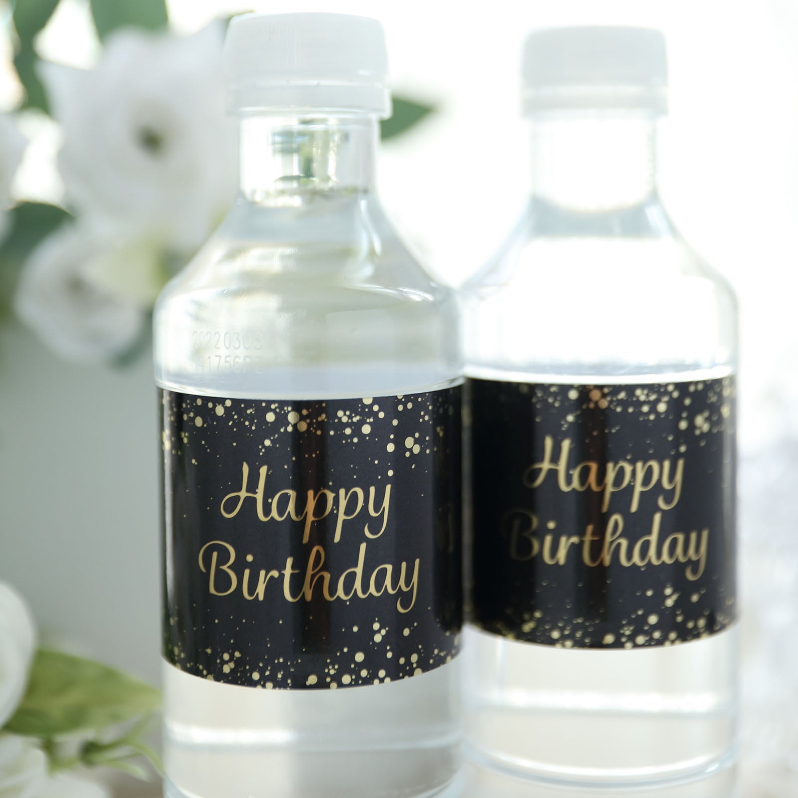 Black and gold water bottle labels with "Happy Birthday" print.