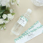 White and green water bottle labels with leaves design.