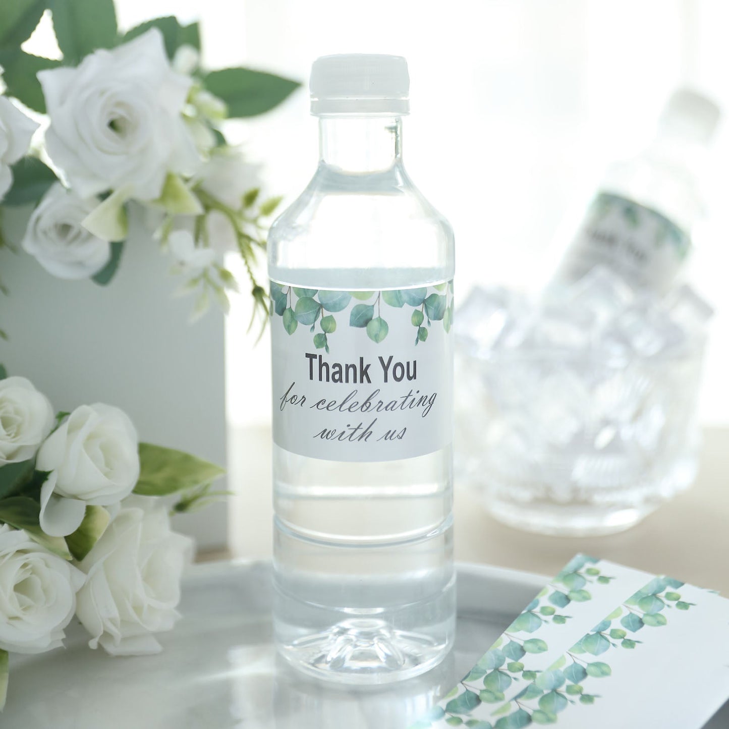 White and green water bottle label with leaves design, "Thank You" message.