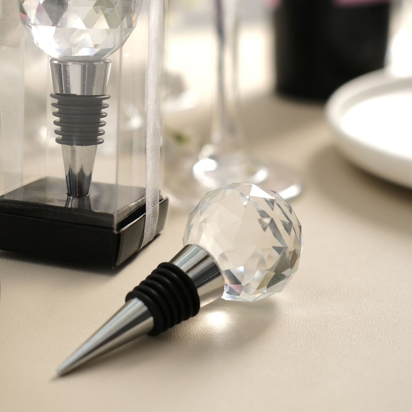 Clear crystal glass ball wine bottle stopper with metal base in a gift box.