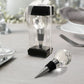 Clear crystal wine bottle stopper in a gift box with ribbon.