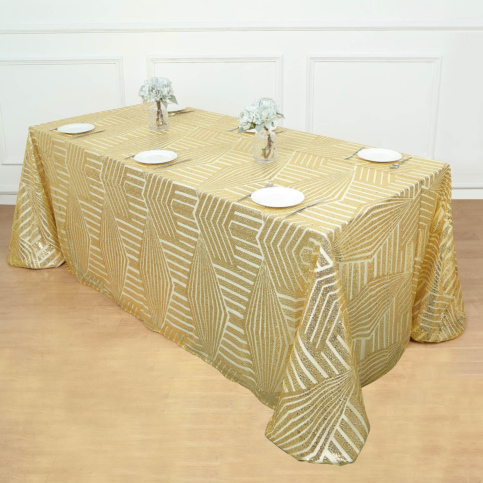 Gold sequin rectangular tablecloth, 90"x132", elegantly draped on a table.