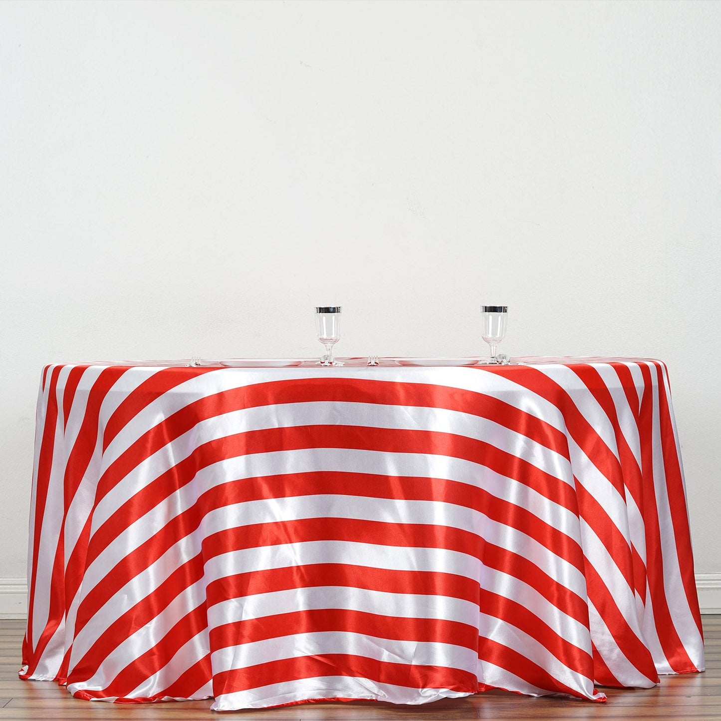 Red and white seamless stripe satin round tablecloth on a table.