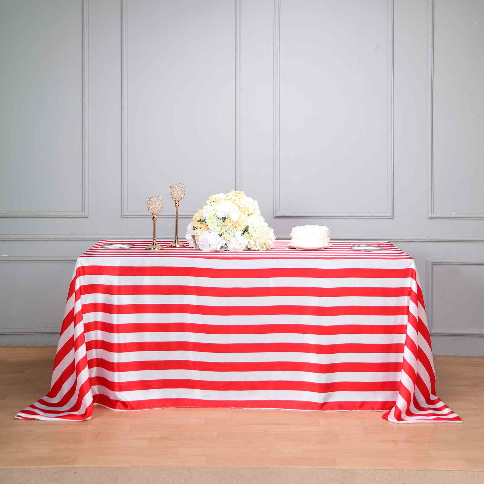 Red and white striped satin tablecloth on a rectangular table.