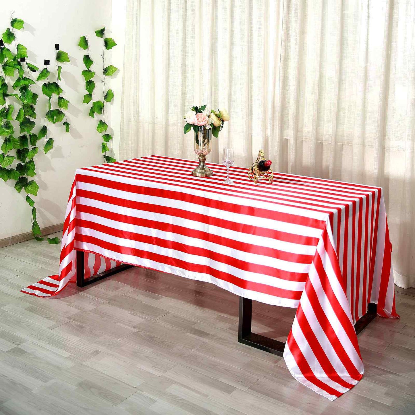 Red and white striped satin tablecloth on a dining table.