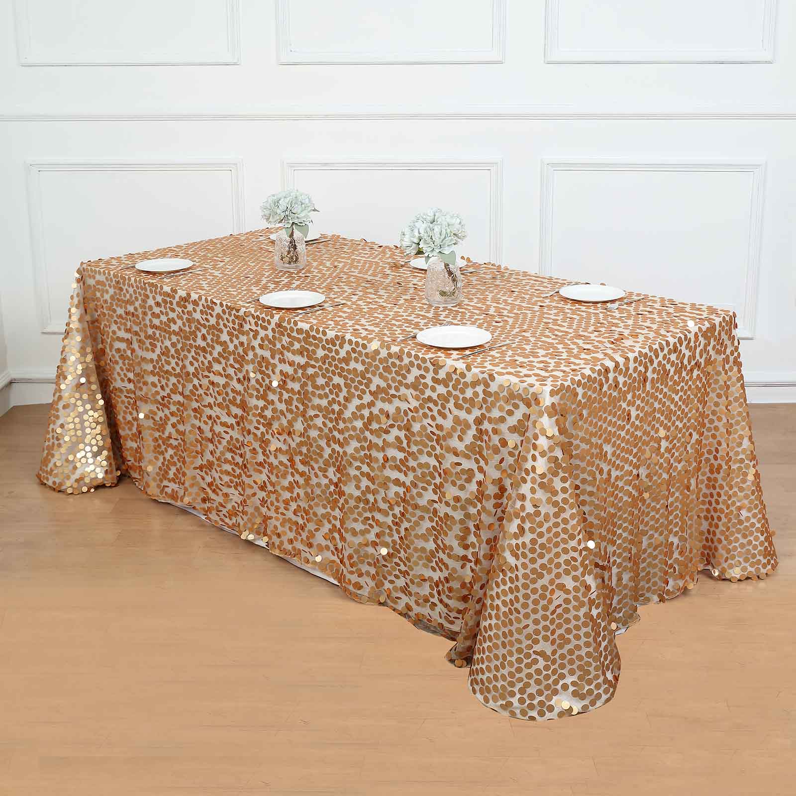 Matte champagne big payette sequin rectangular tablecloth on a wooden table.