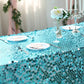 Turquoise sequin tablecloth on a decorated dining table.