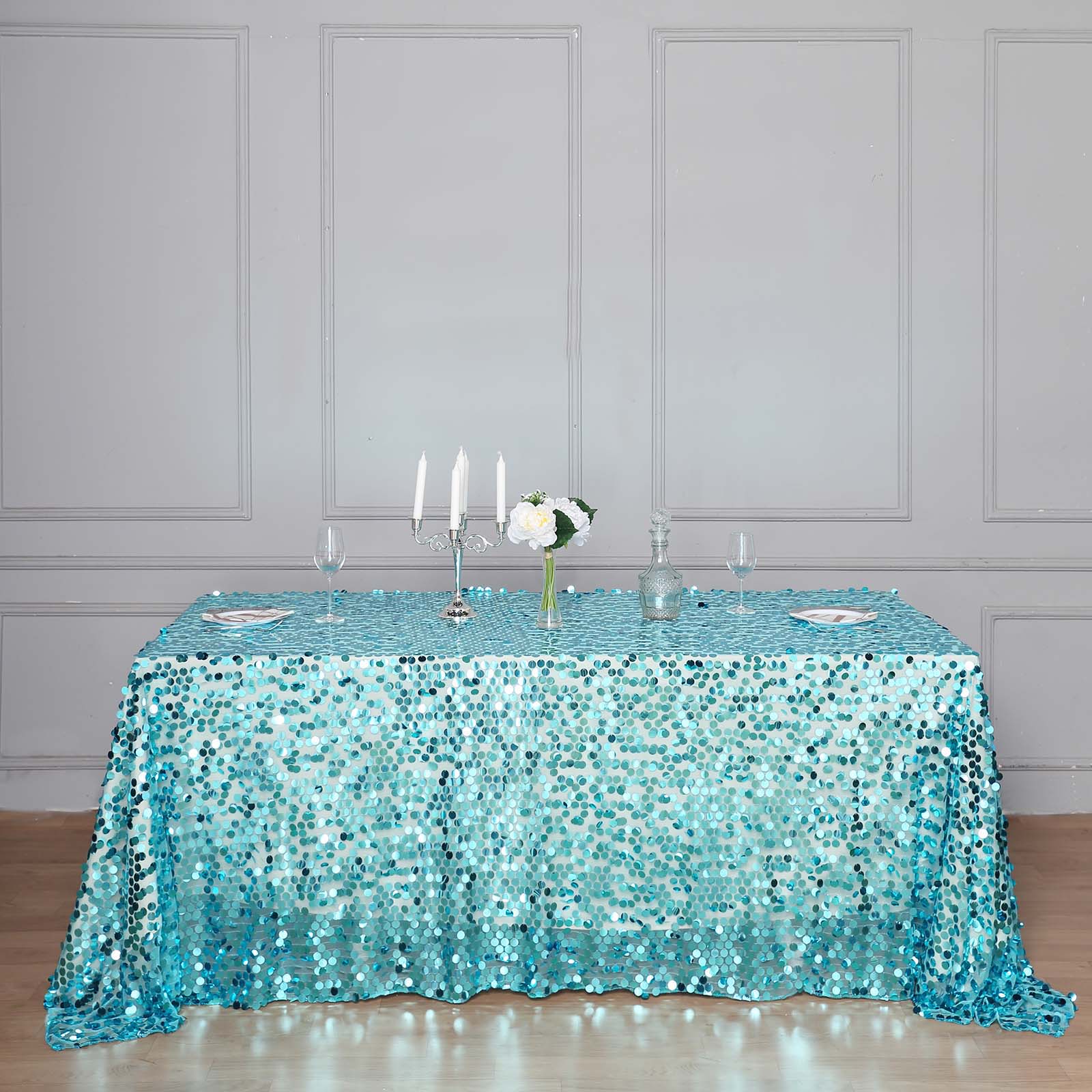 Turquoise sequin rectangle tablecloth for elegant event decor.