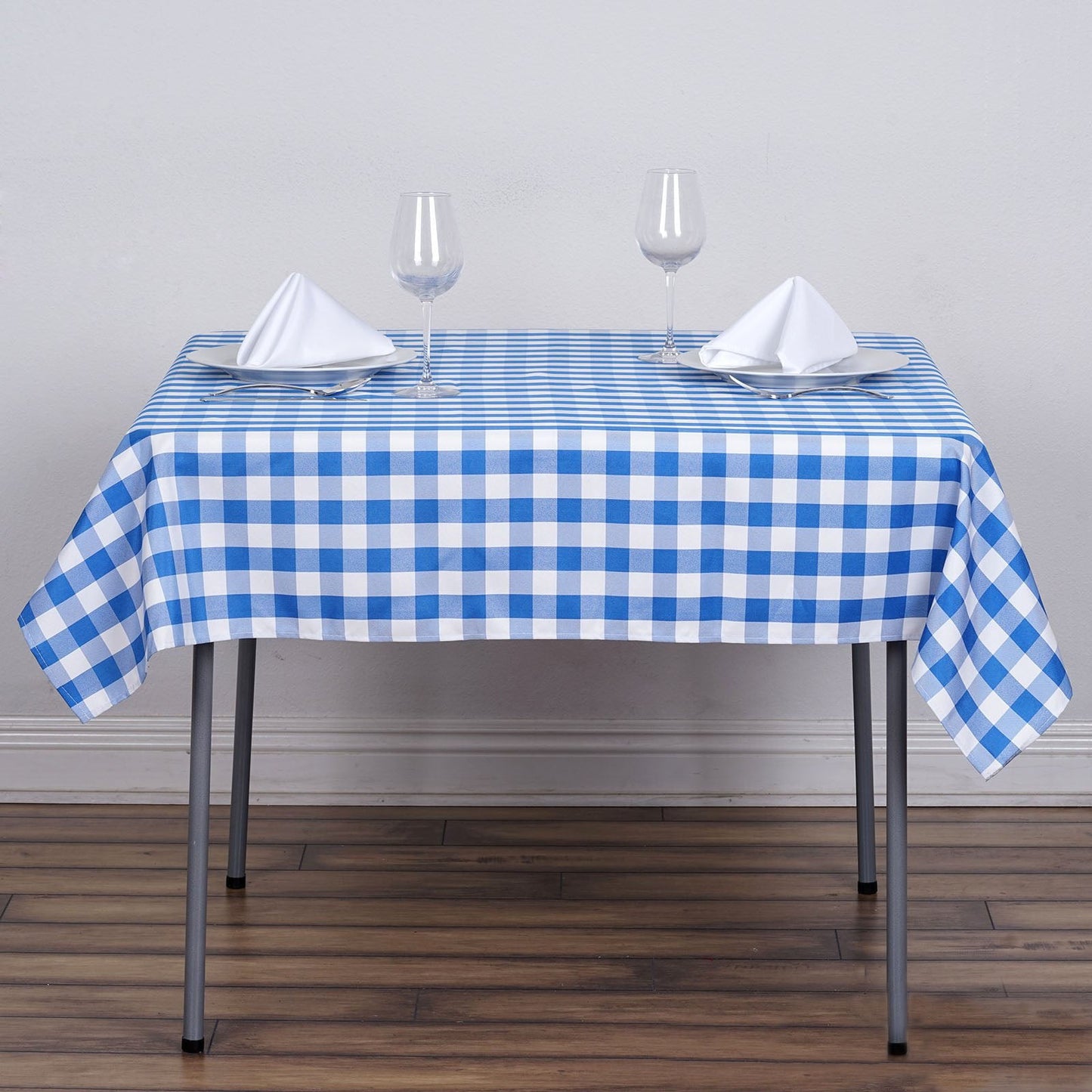 White and blue buffalo plaid square overlay tablecloth.