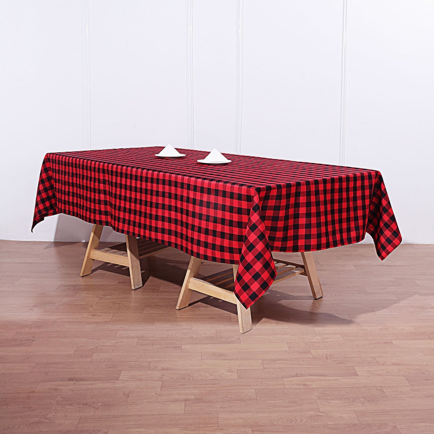 Black and red buffalo plaid tablecloth on a wooden table.
