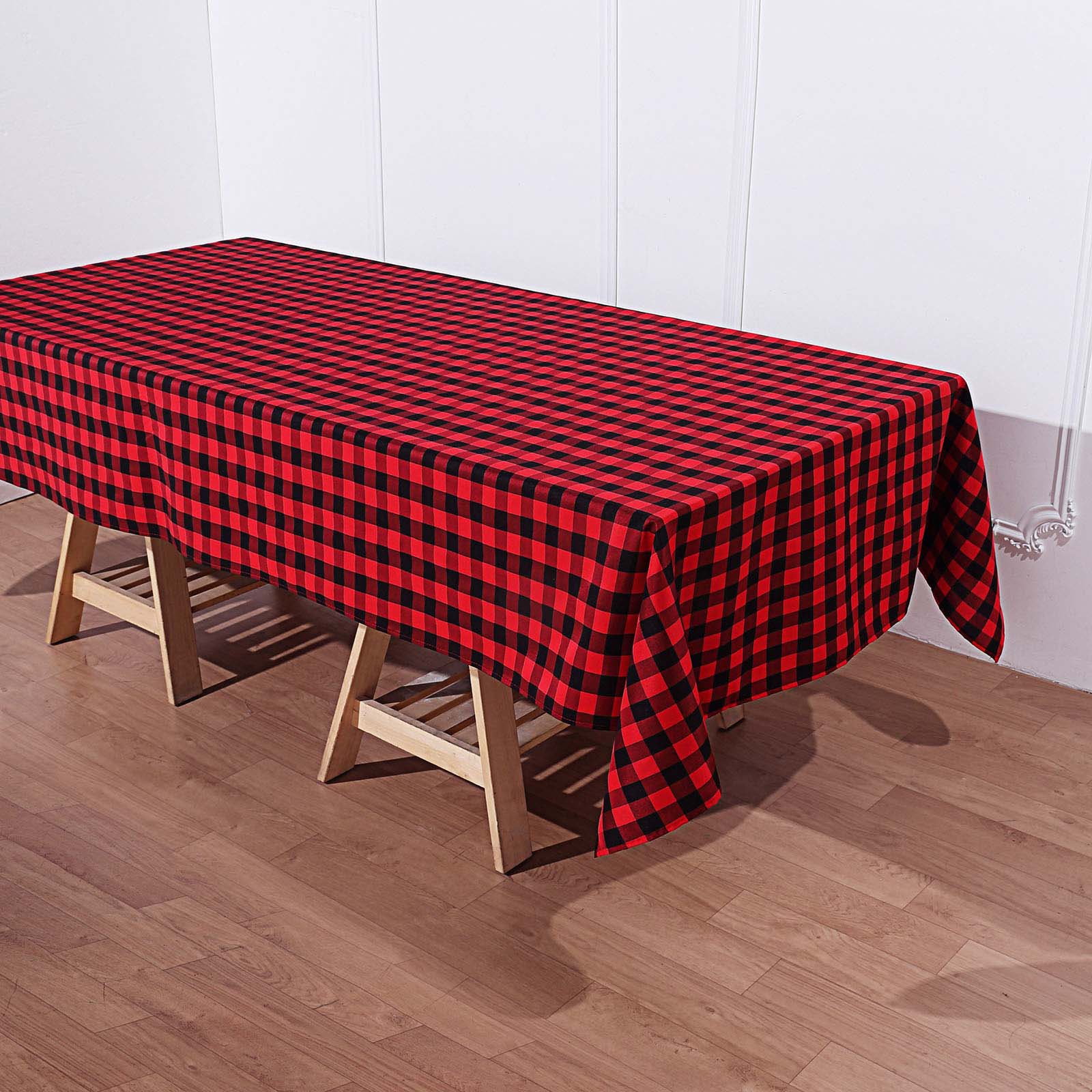 Black/Red Buffalo Plaid Tablecloth on a wooden table.