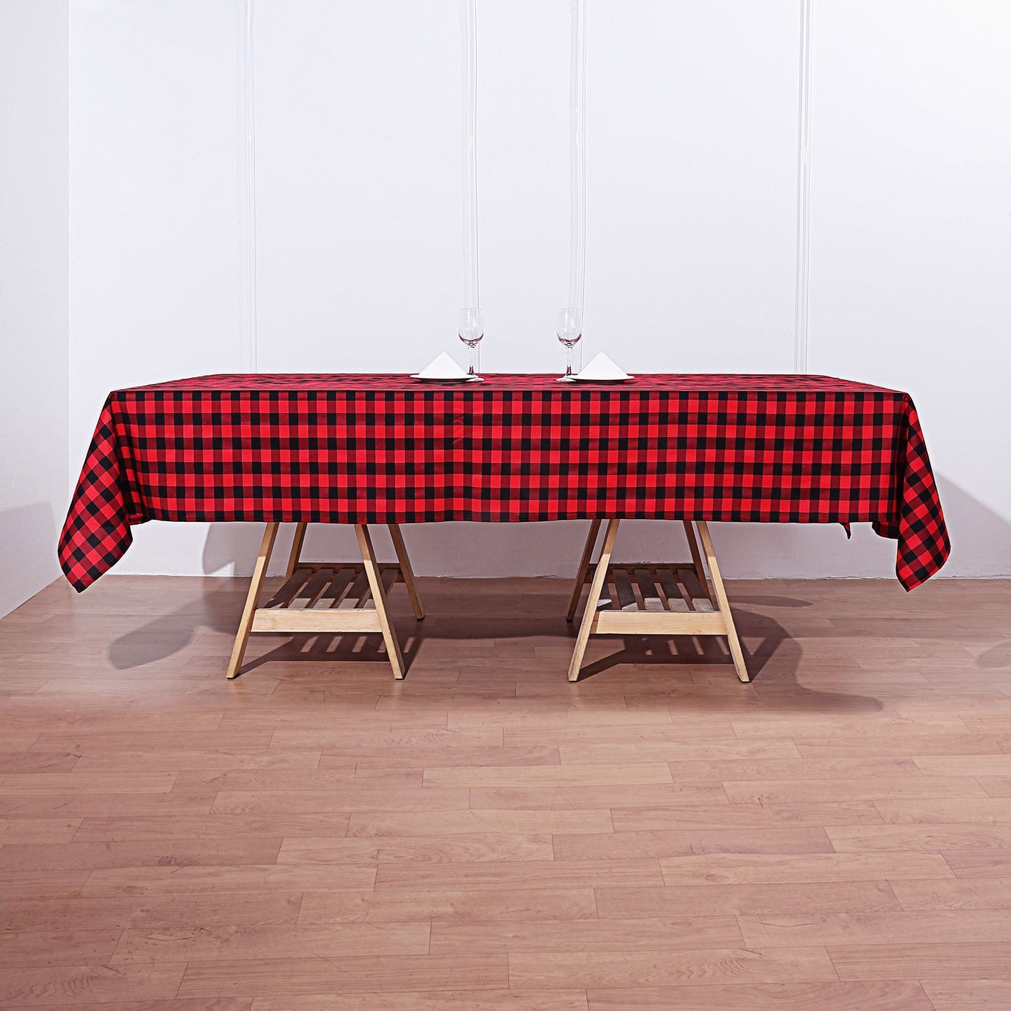 Black and red buffalo plaid tablecloth on a wooden table.