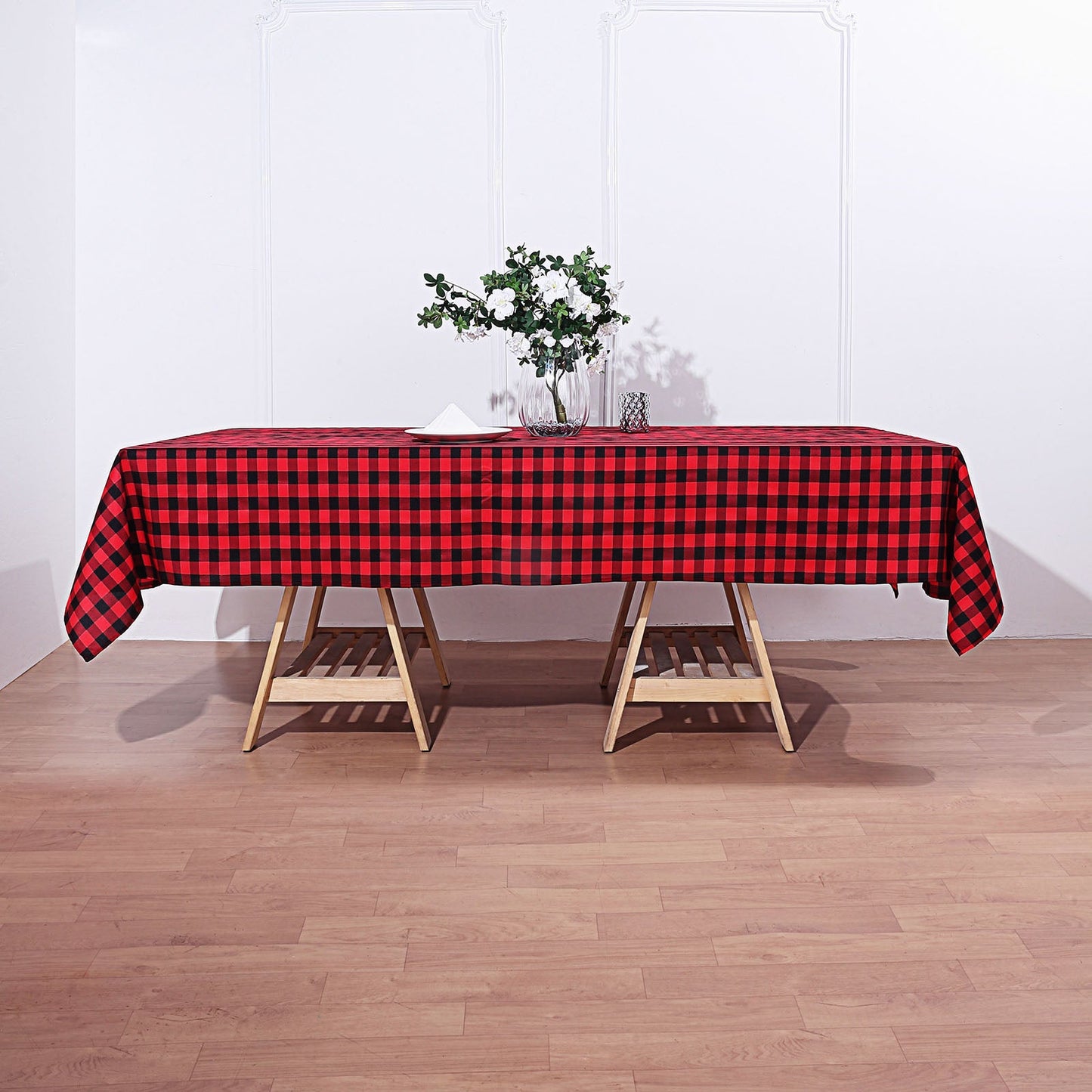 Black/Red Buffalo Plaid Tablecloth on a wooden table.