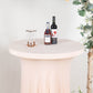 Blush round cocktail table cover with wavy drapes and drinks on top.