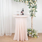 Blush round cocktail table cover with natural wavy drapes.