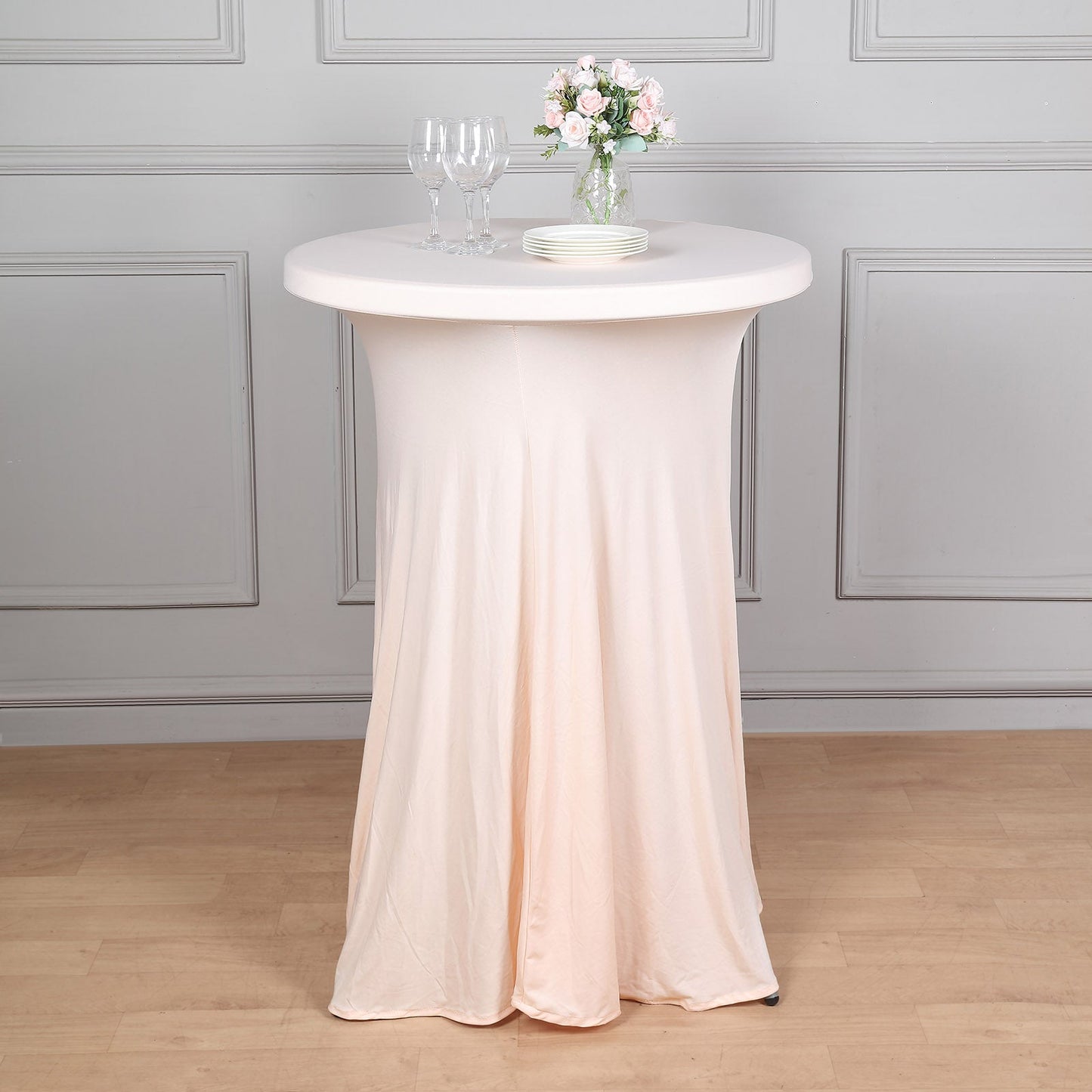 Blush spandex round cocktail table cover with natural wavy drapes.
