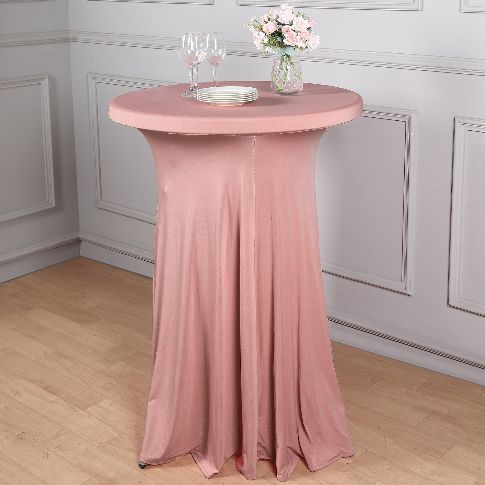 Dusty rose round cocktail table cover with wavy drapes.