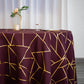 Burgundy tablecloth with gold foil geometric pattern on a table.
